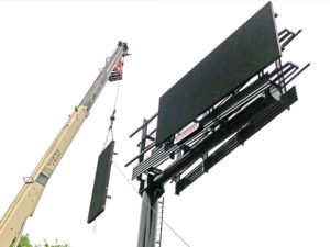 Crane installing a LED Billboard Panel